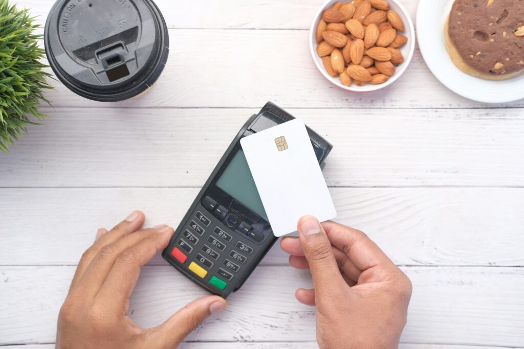 Pessoa fazendo pagamento com cartão de crédito na maquininha